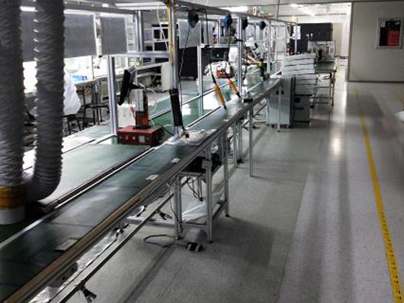 ToF Modern assembly line setup in a factory with conveyor belts and equipment for electronic product manufacturing